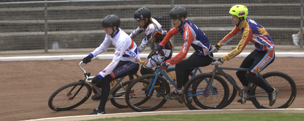 four riders compete for the racing line